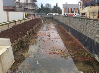 Water feature between a rod and high wall. Sediment has been washed into the channel.