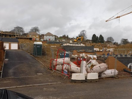 Development site under construction. Crane, fencing, bare earth