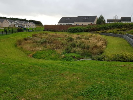 Grassy detention basin in new development