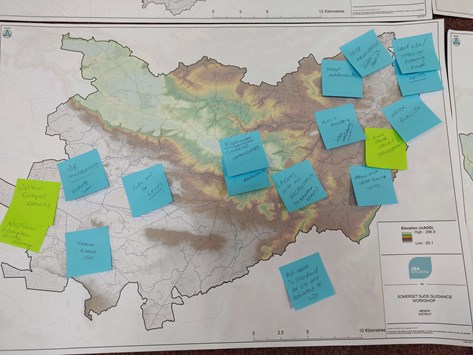 Large map covered with sticky notes containing comments